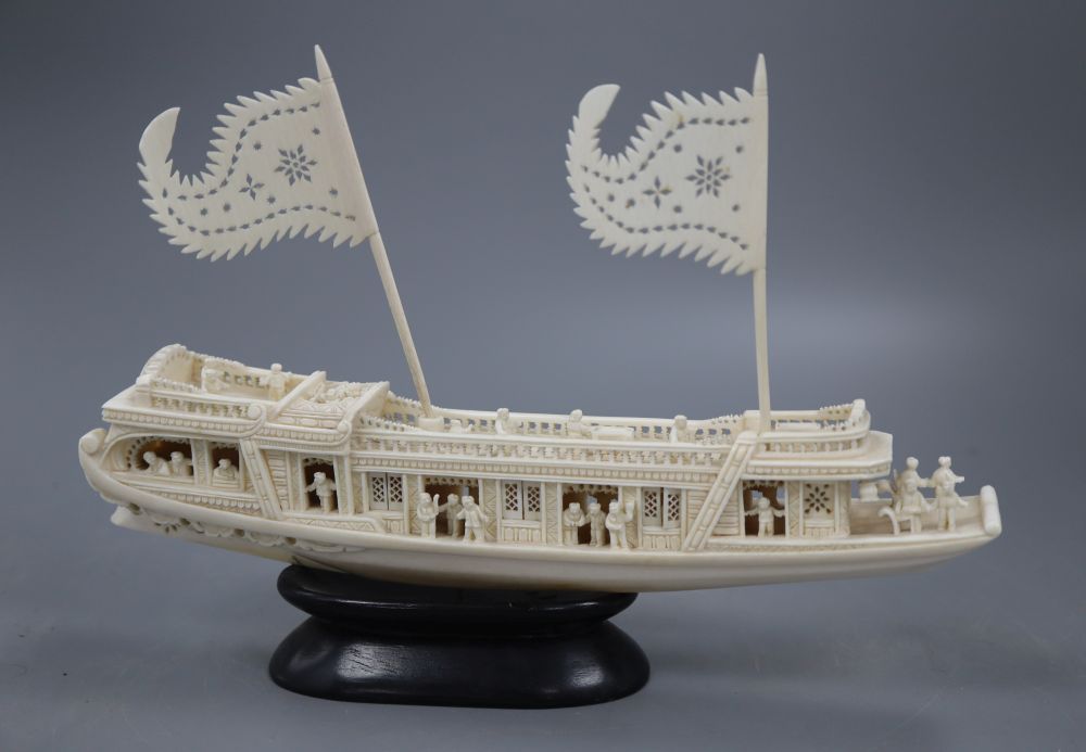 A Chinese carved ivory boat, on stand, length 23cm